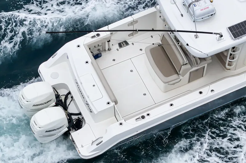 Slide: The Image of 2019 Boston Whaler 330 Outrage boat with dual engines cruising on water. - 17