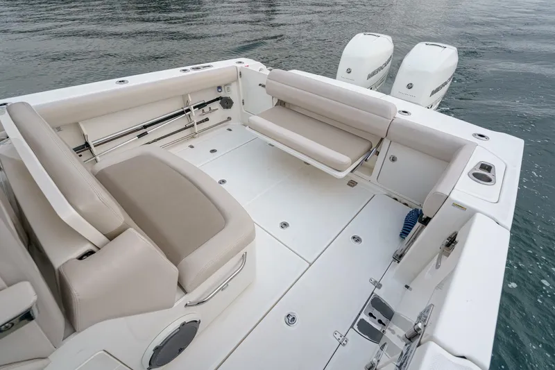 Slide: The Image of 2019 Boston Whaler 330 Outrage boat interior with seating and twin engines. - 19