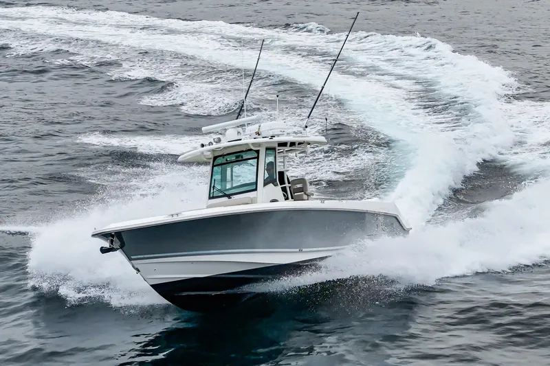 Slide: The Image of 2019 Boston Whaler 330 Outrage cruising swiftly on open water. - 2