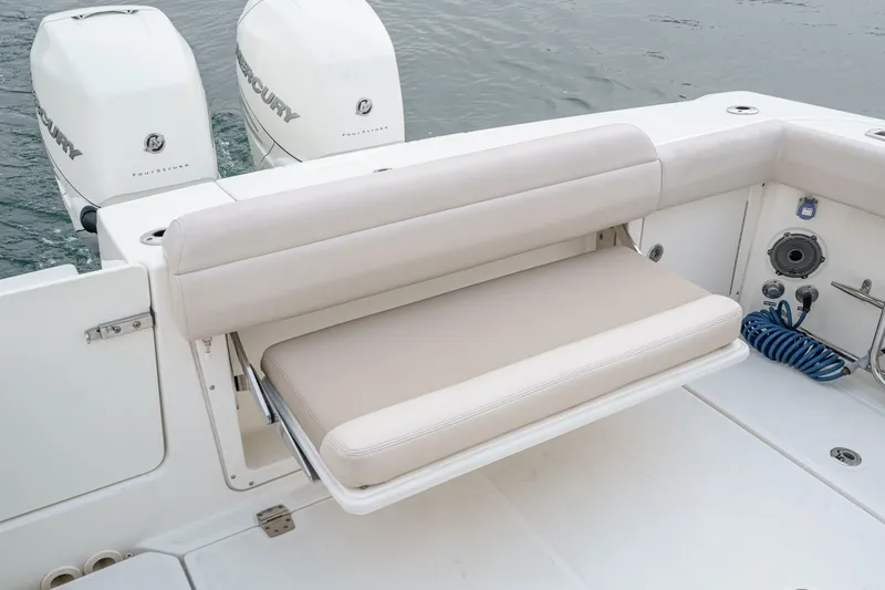 Slide: The Image of 2019 Boston Whaler 330 Outrage boat with foldable seating and twin Mercury engines. - 22