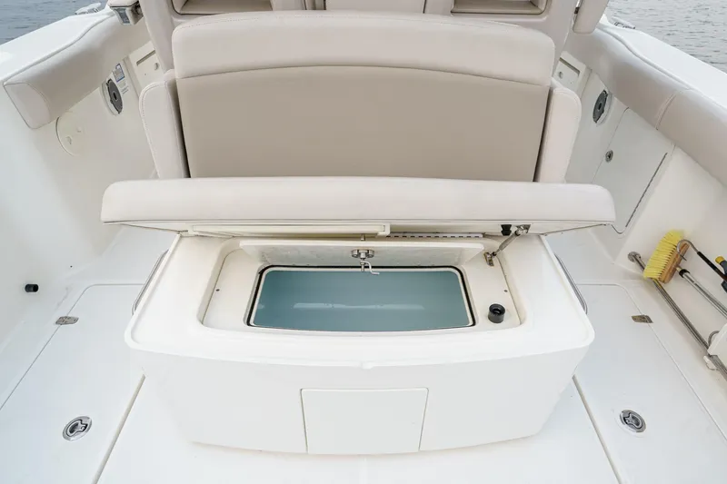 Slide: The Image of 2019 Boston Whaler 330 Outrage boat with open storage compartment on deck. - 28