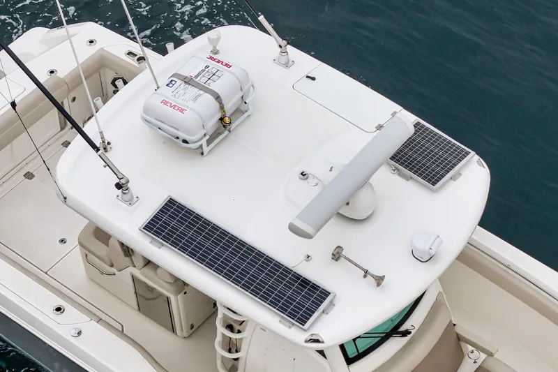 Slide: The Image of 2019 Boston Whaler 330 Outrage boat with solar panels and safety equipment on deck. - 35