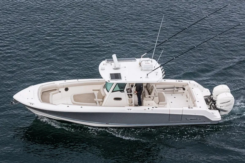 Slide: The Image of 2019 Boston Whaler 330 Outrage boat cruising on open water, side view. - 36