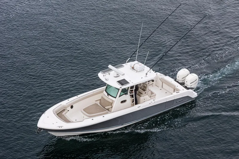 Slide: The Image of 2019 Boston Whaler 330 Outrage boat cruising on open water. - 37