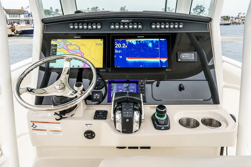 Slide: The Image of 2019 Boston Whaler 330 Outrage helm with advanced navigation displays and controls. - 46