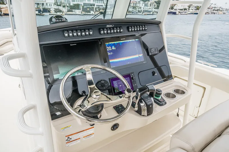 Slide: The Image of 2019 Boston Whaler 330 Outrage helm with advanced navigation and control systems. - 47