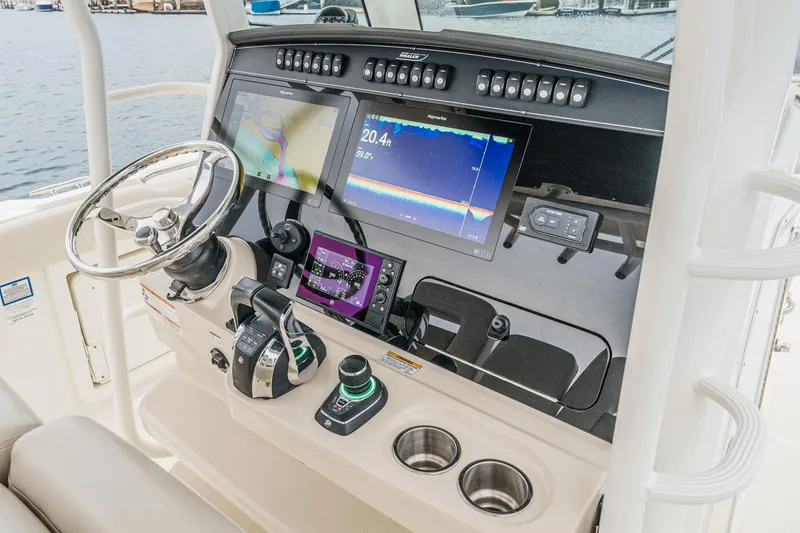 Slide: The Image of 2019 Boston Whaler 330 Outrage dashboard with advanced navigation and control systems. - 48