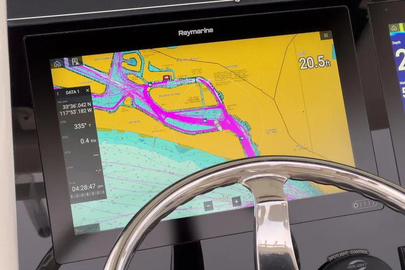Slide: The Image of Raymarine navigation display on 2019 Boston Whaler 330 Outrage, showing nautical chart and steering wheel. - 49
