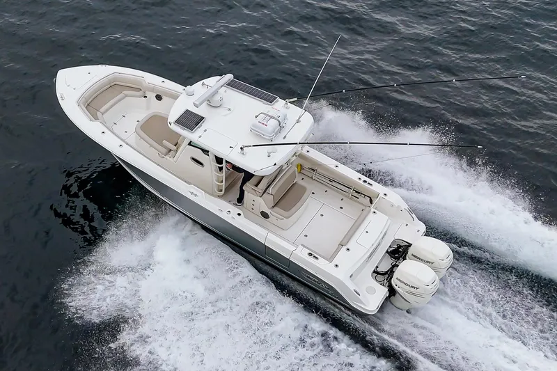 Slide: The Image of 2019 Boston Whaler 330 Outrage boat cruising on open water, aerial view. - 6