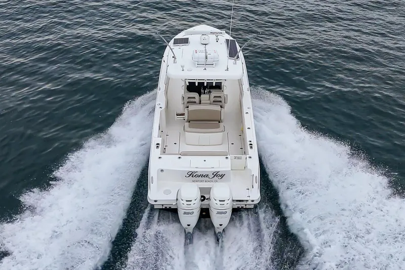 Slide: The Image of 2019 Boston Whaler 330 Outrage boat cruising on open water. - 8