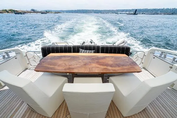 Slide: The Image of Luxury yacht deck with elegant dining area, Marquis 2004 model, cruising on open water. - 15