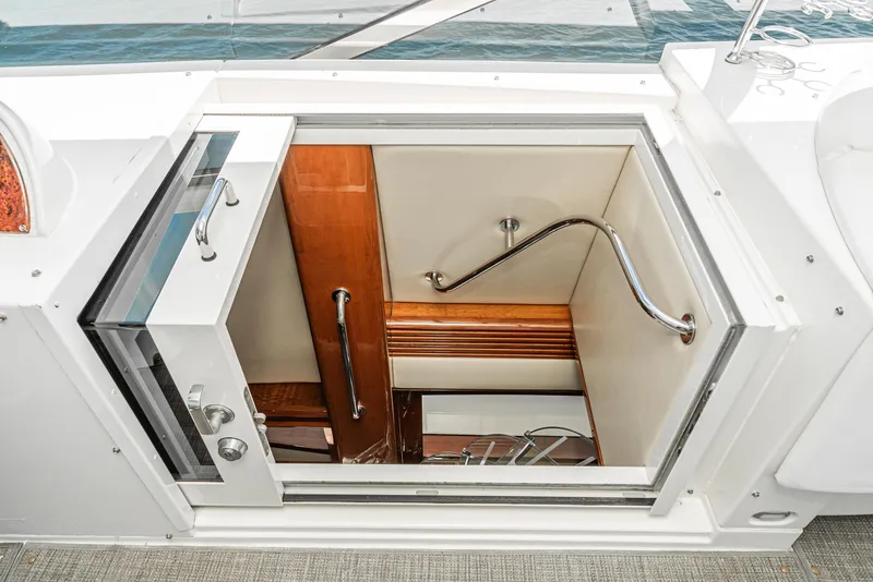 Slide: The Image of Stairway entrance on a 2004 Marquis yacht, featuring wood and metal accents. - 17