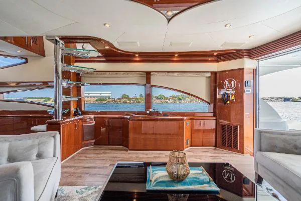 Slide: The Image of Luxurious interior of a 2004 Marquis yacht with elegant wood finishes and waterfront view. - 21