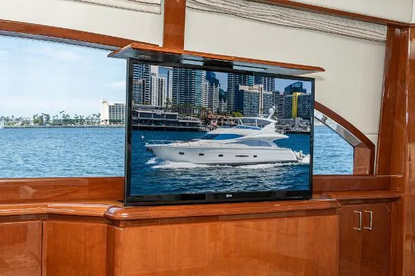 Slide: The Image of Luxurious 2004 Marquis yacht interior with TV displaying a cityscape and yacht. - 22