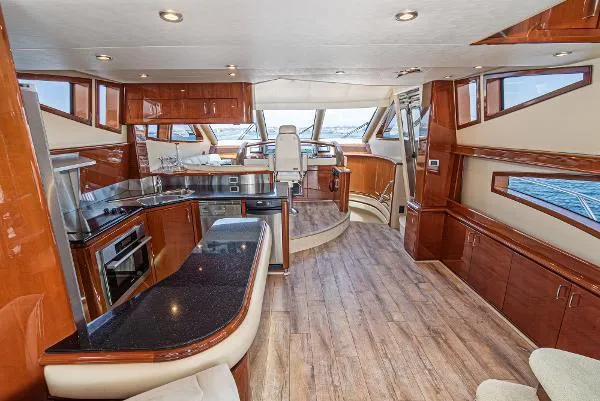 Slide: The Image of Luxurious interior of a 2004 Marquis yacht with modern kitchen and wood flooring. - 23