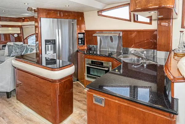 Slide: The Image of Luxurious 2004 Marquis yacht kitchen with modern appliances and elegant wood finishes. - 25