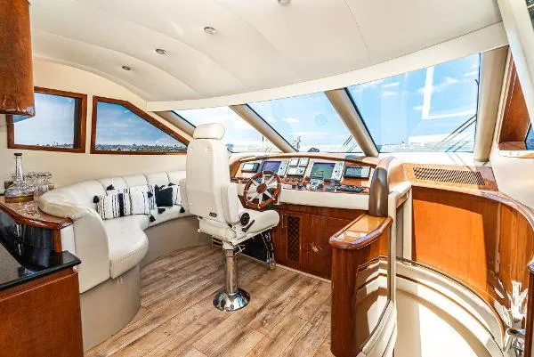 Slide: The Image of Luxurious 2004 Marquis yacht interior with plush seating and modern helm. - 27