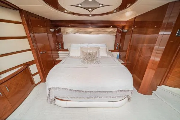 Slide: The Image of Luxurious 2004 Marquis yacht bedroom with elegant wood paneling and plush bedding. - 29