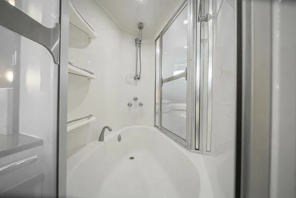 Slide: The Image of Luxurious 2004 Marquis RV bathroom with modern shower and bathtub. - 33