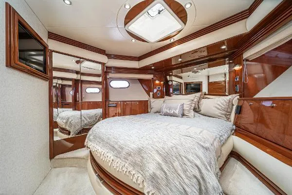 Slide: The Image of Luxurious 2004 Marquis yacht bedroom with elegant wood paneling and plush bedding. - 35