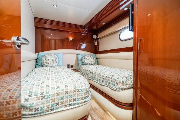 Slide: The Image of Luxurious 2004 Marquis yacht cabin with twin beds and elegant wood paneling. - 38