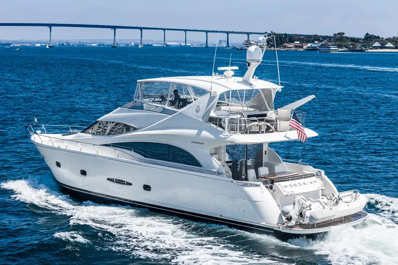 Slide: The Image of Luxurious 2004 Marquis yacht cruising on blue ocean waters. - 43