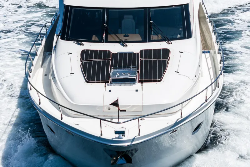 Slide: The Image of 2004 Marquis yacht cruising on open water, featuring sleek design and solar panels. - 47