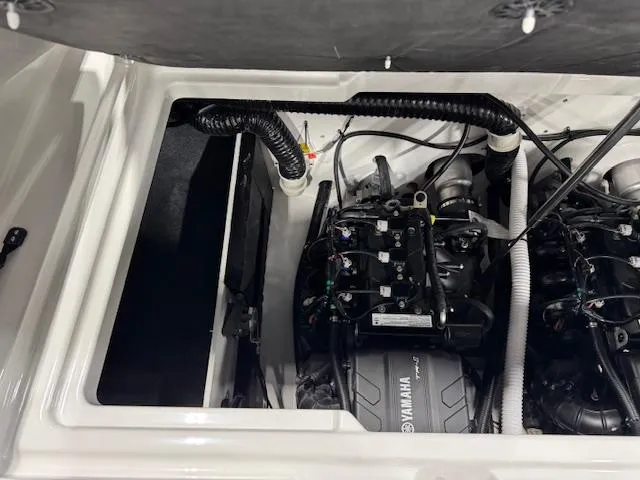 Slide: The Image of Engine compartment of 2025 Yamaha Boats AR220, showcasing internal components and wiring. - 13
