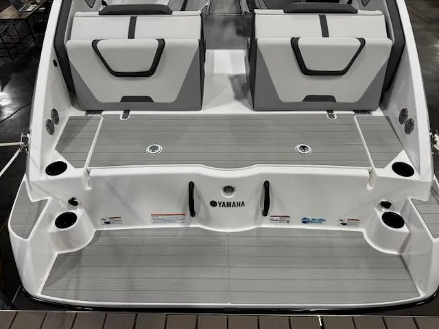 Slide: The Image of 2025 Yamaha Boats AR220 rear deck with seating and cup holders. - 15