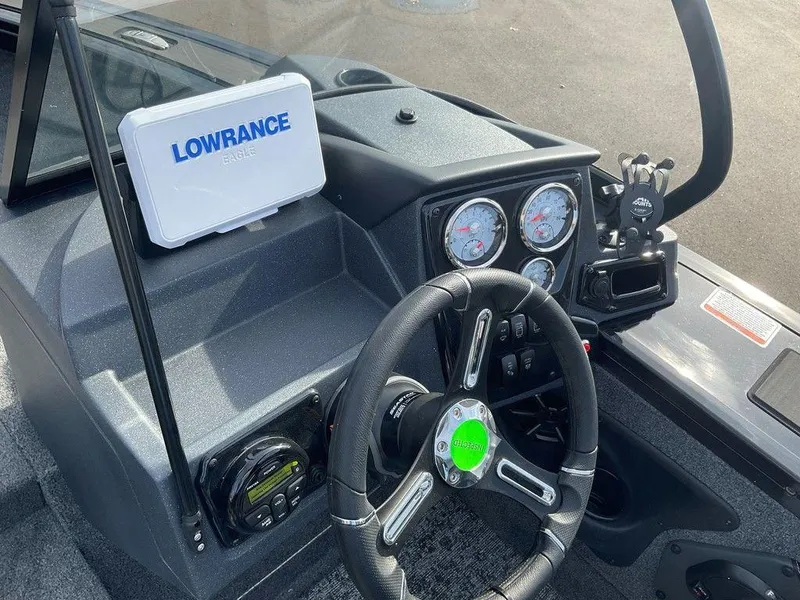 Slide: The Image of 2025 Tracker Targa™ V-18 WT boat dashboard with Lowrance electronics and steering wheel. - 16