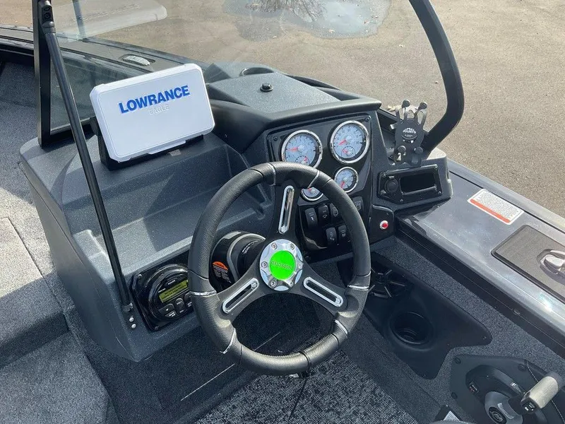 Slide: The Image of 2025 Tracker Targa™ V-18 WT boat dashboard with Lowrance electronics and steering wheel. - 18