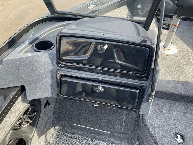 Slide: The Image of 2025 Tracker Targa™ V-18 WT boat dashboard with storage compartments and cup holder. - 19