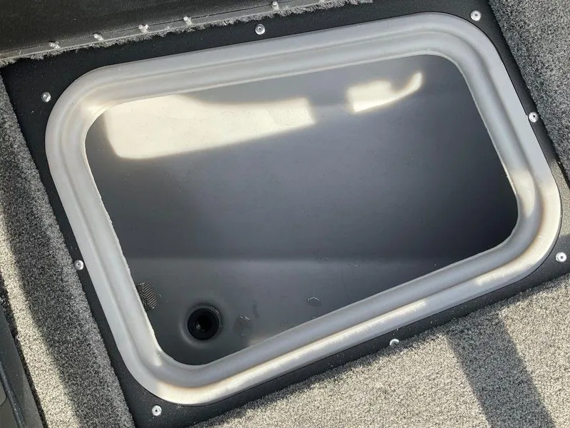 Slide: The Image of 2025 Tracker Targa™ V-18 WT boat storage compartment, gray interior, durable design. - 25
