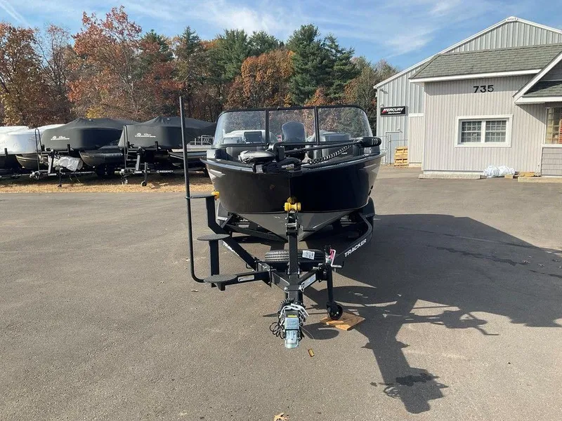 Slide: The Image of 2025 Tracker Targa™ V-18 WT boat on trailer, parked outdoors near building. - 3