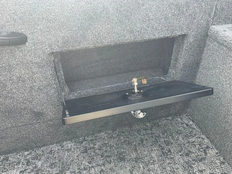 Slide: The Image of 2025 Tracker Targa™ V-18 WT interior storage compartment with foldable shelf. - 35