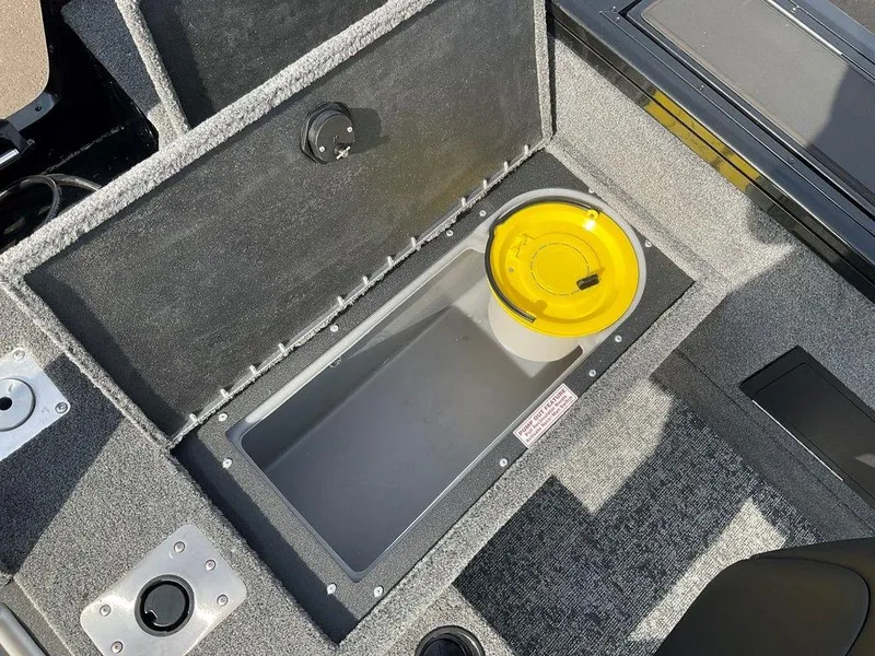 Slide: The Image of 2025 Tracker Targa™ V-18 WT boat storage compartment with yellow lid. - 38