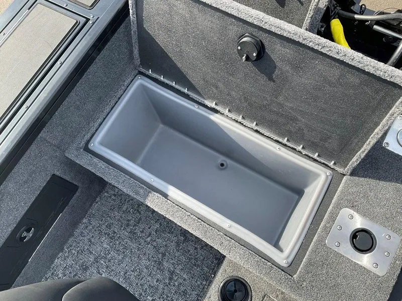 Slide: The Image of 2025 Tracker Targa™ V-18 WT boat storage compartment, gray interior, open lid. - 39