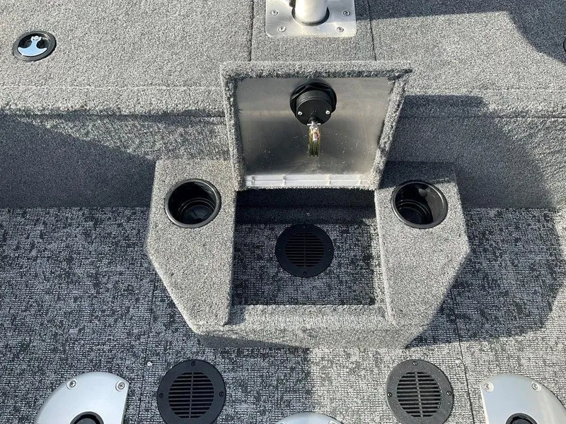 Slide: The Image of 2025 Tracker Targa™ V-18 WT boat interior with cup holders and carpeted flooring. - 41