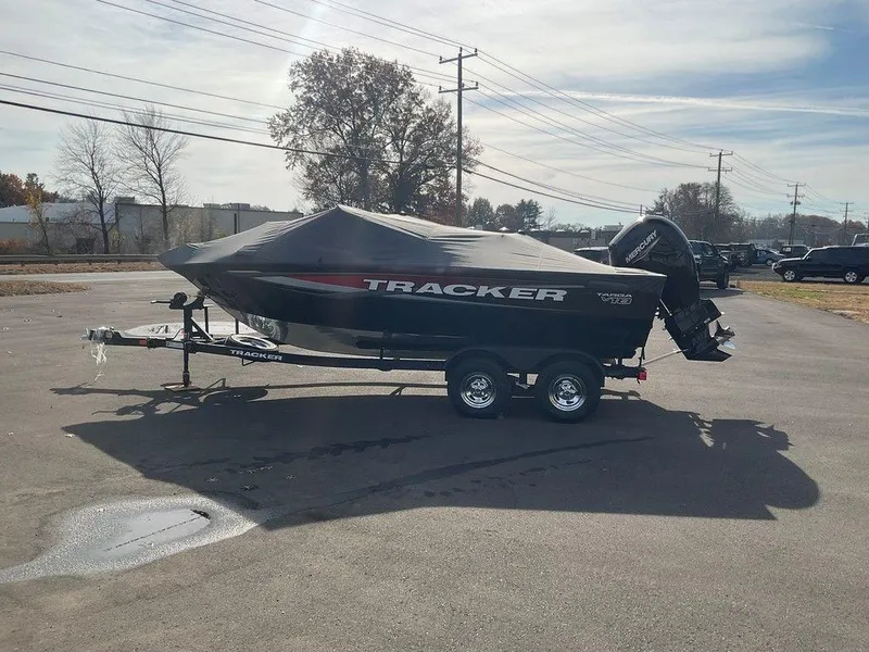 Slide: The Image of 2025 Tracker Targa™ V-18 WT boat on trailer, covered, parked outdoors. - 48