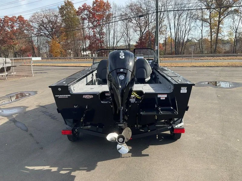 Slide: The Image of 2025 Tracker Targa™ V-18 WT boat with outboard motor, parked outdoors. - 6