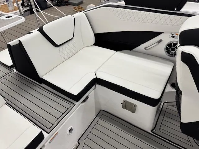 Slide: The Image of 2025 Yamaha Boats 222S interior with white and black seating, modern design, and speaker system. - 10