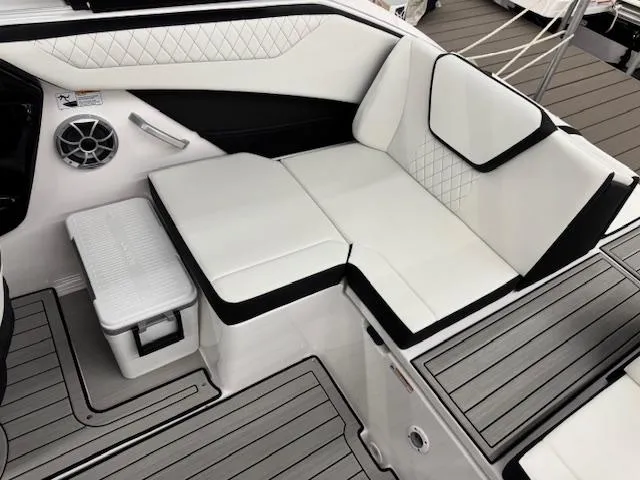 Slide: The Image of 2025 Yamaha Boats 222S interior seating with white and black upholstery, featuring modern design elements. - 12