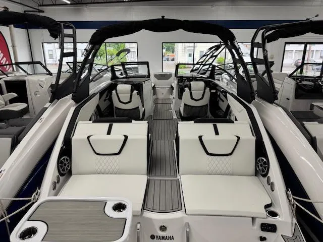 Slide: The Image of 2025 Yamaha Boats 222S interior, featuring sleek white seating and modern design elements. - 17