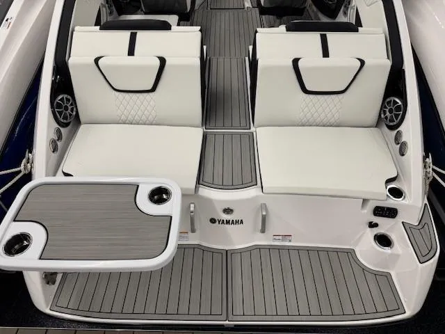 Slide: The Image of 2025 Yamaha Boats 222S interior with white seating and integrated table. - 19