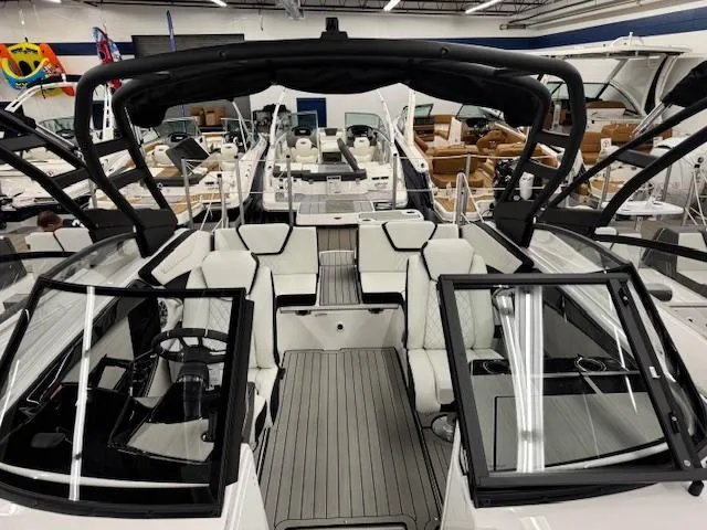 Slide: The Image of 2025 Yamaha Boats 222S interior with sleek seating and modern design in showroom. - 4