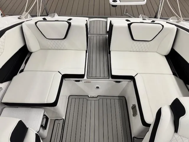 Slide: The Image of 2025 Yamaha Boats 222S interior with white cushioned seating and sleek design. - 9