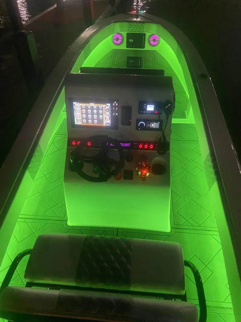 Slide: The Image of 1987 Paramount 21 boat with neon green interior lighting and modern control panel. - 15