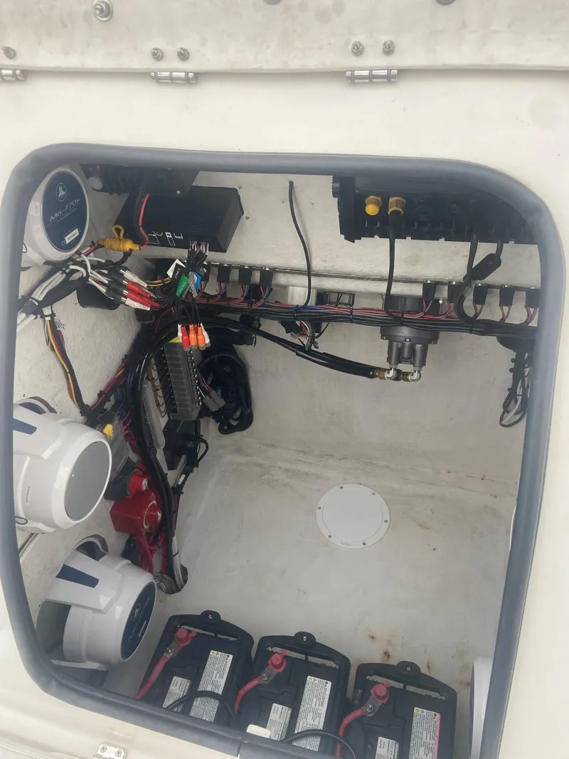 Slide: The Image of Interior of a 1987 Paramount 21 boat showing wiring and battery setup. - 25
