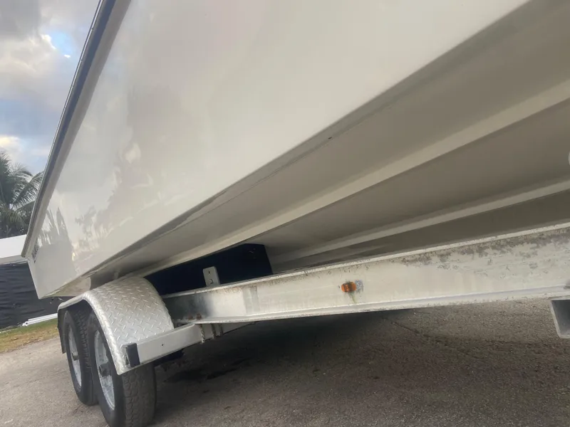 Slide: The Image of 1987 Paramount 21 boat on a dual-axle trailer, side view. - 26