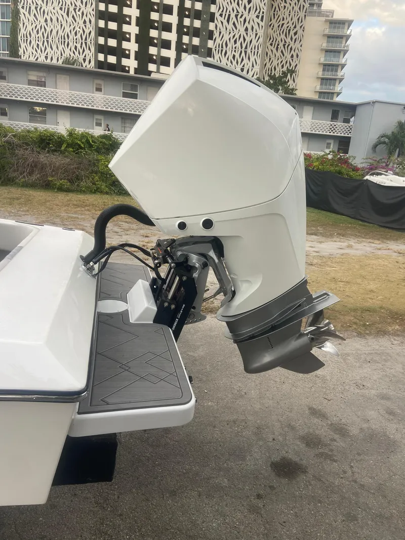 Slide: The Image of 1987 Paramount 21 boat with modern outboard motor, urban background. - 28